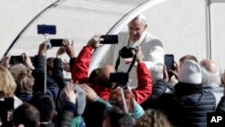 Pope Francis arrives in St.Peter's Square for his weekly general audience, at the Vatican, Wednesday, March 21, 2018.