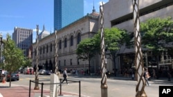 Light spires and one of the stone pillars stand along Boylston Street after installation was finished, Aug. 19, 2019, in Boston to memorialize the Boston Marathon bombing victims at the sites where they were killed. 