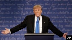 FILE - Republican presidential nominee Donald Trump speaks to Democratic presidential nominee Hillary Clinton during the presidential debate at Hofstra University in Hempstead, N.Y., Sept. 26, 2016. 