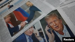 FILE - Daily newspapers with covers dedicated to the recent phone call of Russian President Vladimir Putin and U.S. President Donald Trump are laid out at a newsstand in a street in Moscow, Russia, Feb. 13, 2025. 