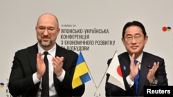 Ukraine's Prime Minister Denys Shmyhal, left, and Japanese Prime Minister Fumio Kishida attend a memorandum of cooperation exchange ceremony during the Japan-Ukraine Conference for Promotion of Economic Growth and Reconstruction at Keidanren Kaikan in Tokyo on Feb. 19, 2024.