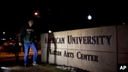 FILE - Students walk through the American University campus in Washington, December 11, 2013.