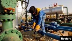 FILE - A worker is seen at the Zarzaitine gas field in In Amenas, 1,600 km (994 miles) southeast of Algiers, Jan. 22, 2013. Algeria closed a land pipeline, Oct. 31, 2021, after a diplomatic dispute with its neighbor Morocco, through which the pipeline passes.