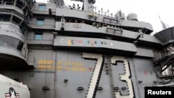 International observers including from Australia, South Korea and Japan watch aircraft operations on USS George Washington during military manoeuvre exercises, known as Keen Sword 15, between the U.S. and Japanese Self-Defense Force in the sea south of Japan.