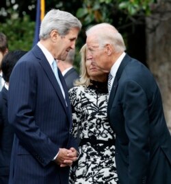 FILE - Secretary of State John Kerry, left, talks with Vice President Joe Biden on Sept. 25, 2015, on the South Lawn of the White House in Washington.