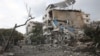 Palestinians inspect the destruction from Israeli airstrikes in Gaza City's al-Rimal neighbourhood early on October 10, 2023.