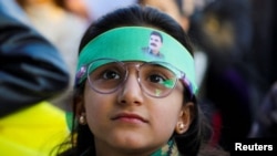 A child looks on as Syrian Kurds gather after militant leader Abdullah Ocalan called on his Kurdistan Workers' Party to disarm, a move that could end its 40-year conflict with Ankara and have consequences for the region, in Hasakah, Syria, Feb. 27, 2025.