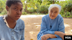 Sifa Maulana, 14, and Mother Maria speak with a reporter outside the Mater Dei Monastery in Nampula, northern Mozambique, May 30, 2021. 