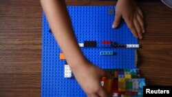 Sawyer Roellchen, 5, plays with Legos in his family's new home at Lackland Air Force Base in San Antonio, Texas, Nov. 16, 2019.