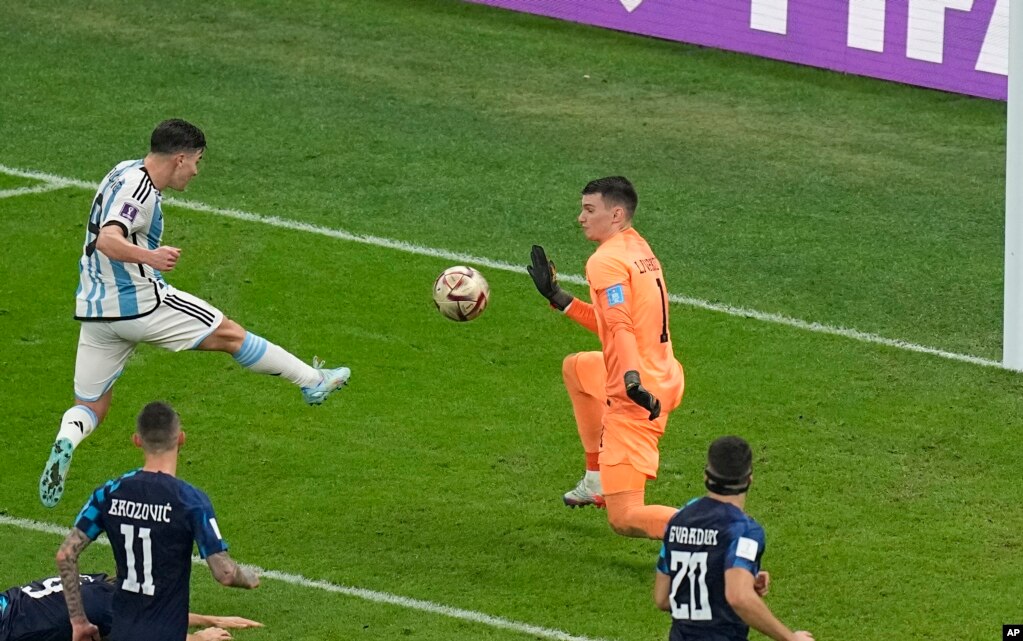 El argentino Julián Álvarez, a la izquierda, anota el segundo gol de su equipo durante el partido de fútbol semifinal de la Copa del Mundo, el martes 13 de diciembre de 2022. (Foto AP/Pavel Golovkin)