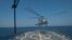 FILE - A SH-60 Seahawk helicopter takes off from the flight deck of USS Jason Dunham during a joint exercise with the Montenegrin navy March 16, 2015 in the Mediterranean Sea.