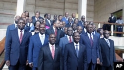 The new Ivory Coast government pose with President Alassane Ouattara after a council, at the Presidential Palace in Abidjan June 3, 2011