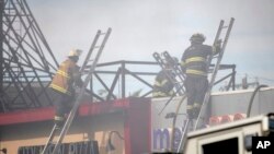 Firefighters battle a blaze in Philadelphia, June 1, 2020, in the aftermath of protest and unrest in reaction to the death of George Floyd. 