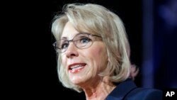 FILE - Education Secretary Betsy DeVos speaks during a dinner hosted by the Washington Policy Center in Bellevue, Wash., Oct. 13, 2017. 