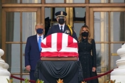 President Donald Trump and first lady Melania Trump pay respects as Justice Ruth Bader Ginsburg lies in repose at the Supreme Court building, Sept. 24, 2020, in Washington.