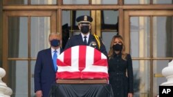 President Donald Trump and first lady Melania Trump pay respects as Justice Ruth Bader Ginsburg lies in repose at the Supreme Court building, Sept. 24, 2020, in Washington.