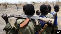 A South Sudanese army soldier holds his rifle near an oil field in Unity State April 22, 2012. South Sudan says it has withdrawn thousands of troops from the disputed border area. (Reuters)