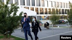 Students walk out of the Ecole Hoteliere de Lausanne after its students were put under quarantine in Lausanne, Switzerland, Sept. 23, 2020.