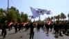 FILE - Iran-backed militia fighters march in central Baghdad, Iraq, June 29, 2021. Iraqi Shiite militias are showing a degree of defiance of their patron Iran by escalating rocket and drone attacks on the U.S. presence in the country.