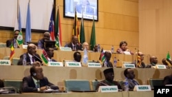 African Union chairman Moussa Faki (2nd L-top) is seen sitting with members of the Intergovernmental Authority for Development (IGAD) as they attend a signing ceremony for the cease-fire agreement amongst South Sudanese parties to end the four-year war in the country, at the headquarters of African Union in the Ethiopian capital Addis Ababa, Dec 21, 2017.