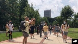 Protesters march opposing in-person classes at Georgia Tech in Atlanta, Aug. 17, 2020. More of the state public universities are opening for the fall term.