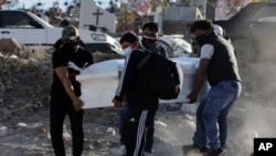 Family members carry the coffin that contain the remains of Giro Quispe who died from complications related to the new coronavirus, at El Cebollar cemetery, in Arequipa, Peru, June 25, 2021.