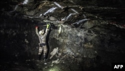 (FILES) A miner works underground, at the Anglo American Bathopele Mine in Runstenburg, North Western Province of South Africa, some 170 km from Johannesburg on June 11, 2015.