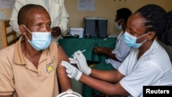 A man receives a vaccine against the coronavirus at the Masaka hospital in Kigali, Rwanda, March 5, 2021. 