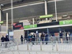 People line up for coronavirus vaccine shots at the Stade de France in Saint Denis, which is seeing some of France's highest coronavirus caseloads. (Lisa Bryant/VOA)