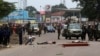 The bodies of people killed during election protests lie in the street, as Congolese troops stand near by in Kinshasa, Democratic Republic of Congo, Sept. 19, 2016.