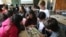 FILE - Students look at a World Cup sticker book during their Portuguese class, in Sao Paulo, Brazil, May 21, 2018.