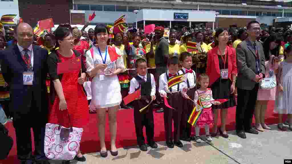 Some of the Chinese people resident in Zimbabwe who turned up at Harare International Airport to welcome President Xi Jinping. (Photo: Irwin Chifera)