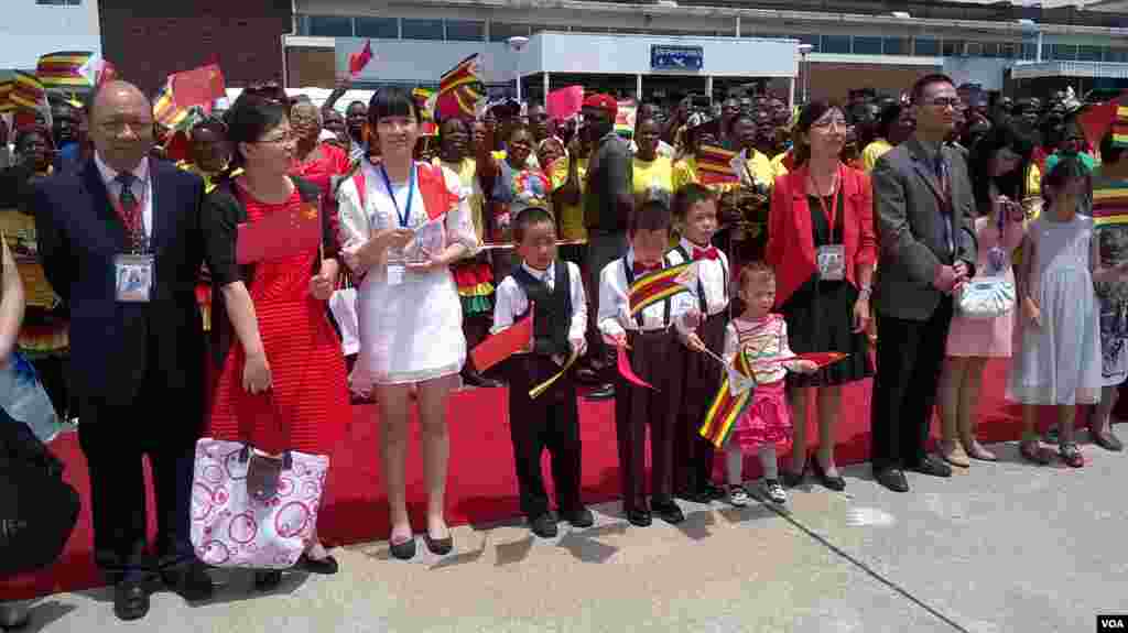 Some of the Chinese people resident in Zimbabwe who turned up at Harare International Airport to welcome President Xi Jinping. (Photo: Irwin Chifera)