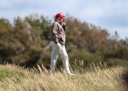 FILE - U.S. Presidential contender Donald Trump walks near the 16th green of the Turnberry golf course in Turnberry, Scotland, July 30, 2015.