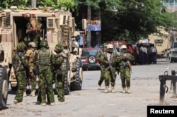 FILE – Kenyan police officers patrol as part of a peacekeeping mission in Port-au-Prince, Haiti, July 17, 2024.