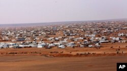 FILE - A Jordanian soldier stands guard at the northeastern border with Syria, close to the informal Rukban camp for displaced Syrians, Feb. 14, 2017.