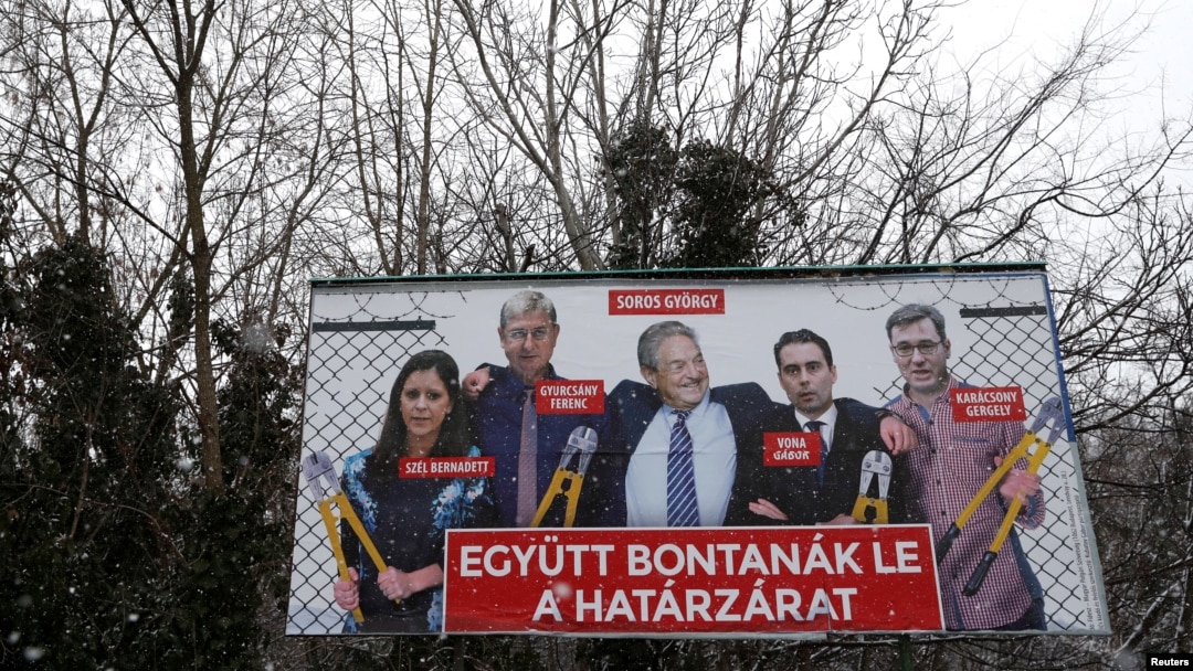 FILE - A government billboard shows George Soros (C) and opposition party leaders in Budapest, Hungary, Feb. 20, 2018. The billboard reads: 'They would dismantle the border fence together.'