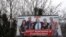 FILE - A government billboard shows George Soros (C) and opposition party leaders in Budapest, Hungary, Feb. 20, 2018. The billboard reads: 'They would dismantle the border fence together.'