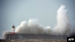 Waves crash over Newhaven Lighthouse on the south coast of England on Feb. 8, 2016, as the latest storm hits the country.