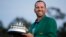 Spain's Sergio Garcia holds the first-place trophy while wearing the winner's green jacket after taking after Masters' title in a playoff, April 9, 2017, in Augusta, Georgia.