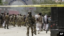 A soldier outside the Spozhmai hotel where officials say Taliban insurgents killed almost two dozen people, most of them civilians, just north of Kabul, June 22, 2012.