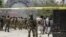 A soldier from NATO-led forces, center, outside the Spozhmai hotel on Lake Qargha where security officials say Taliban insurgents killed almost two dozen people, most of them civilians, in an attack that began before midnight Thursday, just north
of Kabu