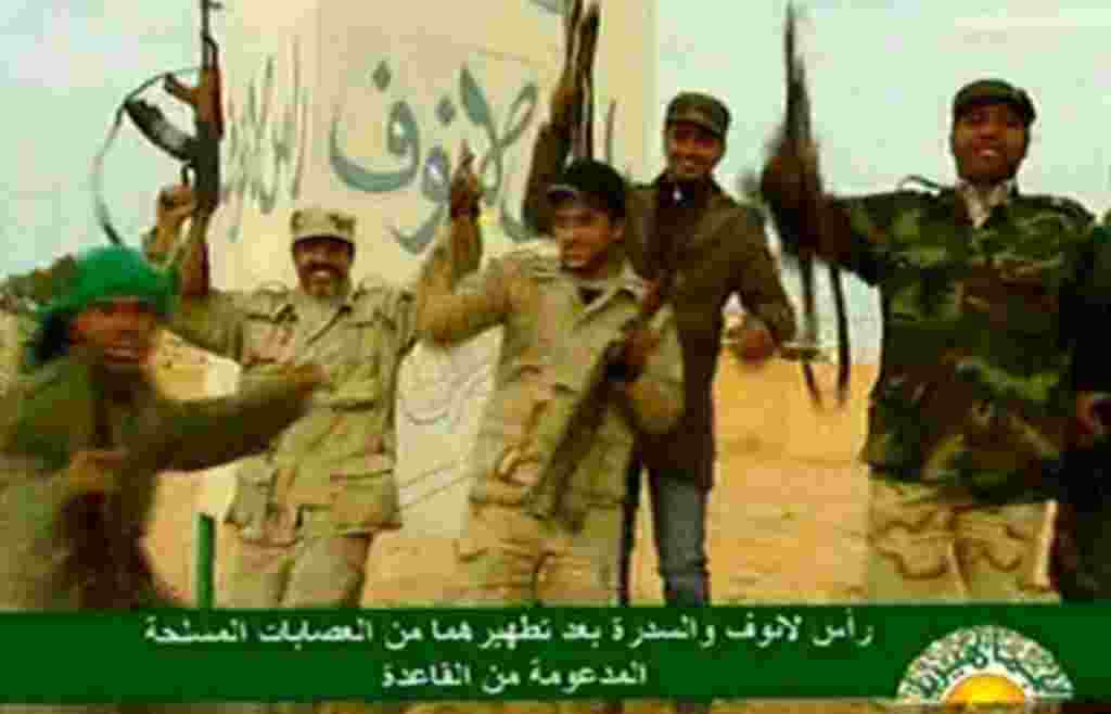 An image grab taken from Libya's state television on March 11, 2011 shows Libyan leader Moammar Gadhafi's forces celebrating after driving back anti-government rebel fighters in the oil town of Ras Lanuf