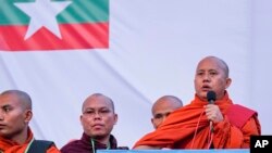 Buddhist monk and anti-Muslim community leader Wirathu, right, speaks during a nationalist rally in Yangon, Myanmar, May 5, 2019.