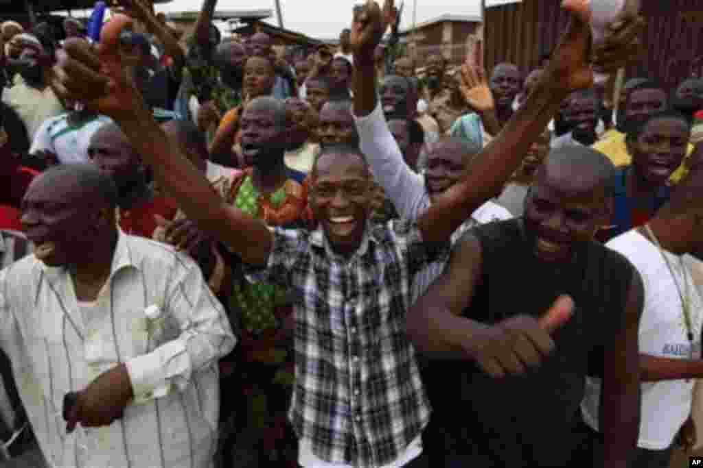 Supporters of the Accord Party celebrate after they discovered they were reportedly leading after the counting of an election ballot papers at Oyeleye ward in Ibadan, Nigeria, Saturday, April 9, 2011