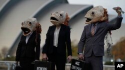Campaigners from the environment group Ocean Rebellion wearing fish head masks take part in a protest against the Marine Stewardship Council (MSC), near the venue of the COP26 U.N. Climate Summit in Glasgow, Scotland.