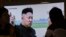 FILE - People watch a TV news program showing a file image of North Korean leader Kim Jong Un, at the Seoul Railway Station in Seoul, South Korea, Feb. 27, 2017. 