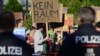 People protest with placards reading "No room for the AFD" against the far-right Alternative for Germany AfD party, during the Brandenburg state elections in Potsdam, nearby the venue of the party's electoral evening, Sept. 22, 2024. 