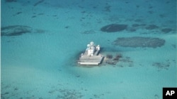 FILE - In this photo taken Feb. 28, 2013 by a surveillance plane, and released on May 15, 2014, by the Philippine Department of Foreign Affairs, Chinese-made structures stands on the Johnson Reef, called Mabini by the Philippines and Chigua by China, in the Spratly Islands in South China Sea.