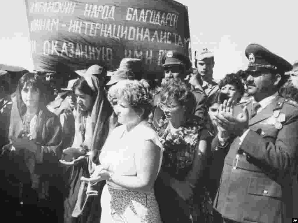 Afghanistan civilians bid farewell to departing Soviet troops in Shindand, Afghanistan October 17, 1986.